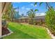 Backyard featuring lush landscaping, mature trees, green grass, and privacy fencing at 601 Boca Ciega Isle Dr, St Pete Beach, FL 33706