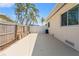 Backyard featuring a concrete slab, grass, landscaping, and a wood privacy fence at 601 Boca Ciega Isle Dr, St Pete Beach, FL 33706