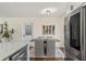Bright dining area with modern light fixture and stainless steel refrigerator at 601 Boca Ciega Isle Dr, St Pete Beach, FL 33706