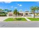 Inviting one-story home with a well-manicured lawn, complemented by mature palm trees and an extra-long driveway at 601 Boca Ciega Isle Dr, St Pete Beach, FL 33706
