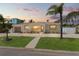 Charming single-story home with a well-manicured lawn, mature palm trees, and a spacious driveway at 601 Boca Ciega Isle Dr, St Pete Beach, FL 33706