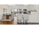Modern kitchen with stainless steel appliances, white cabinetry, and a breakfast bar overlooking the dining area at 601 Boca Ciega Isle Dr, St Pete Beach, FL 33706