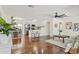 Bright living room featuring hardwood floors, neutral decor, and seamless flow to kitchen and dining spaces at 601 Boca Ciega Isle Dr, St Pete Beach, FL 33706