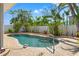 Backyard in-ground pool is surrounded by brick and lush landscaping for privacy at 601 Boca Ciega Isle Dr, St Pete Beach, FL 33706