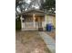 Charming single-story home featuring a cozy front porch and yellow siding at 6200 N 44Th St, Tampa, FL 33610