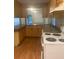 Functional kitchen features wooden cabinets and a white electric range at 6200 N 44Th St, Tampa, FL 33610