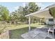Back yard featuring a covered patio, chain-link fence, trees and lawn at 6544 S West Shore Cir, Tampa, FL 33616