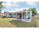 Backyard featuring a covered patio and green lawn, offering an outdoor space for relaxation and activities at 6544 S West Shore Cir, Tampa, FL 33616
