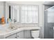 Compact bathroom features a window, sink, toilet and shower providing an efficient and well-lit space at 6544 S West Shore Cir, Tampa, FL 33616