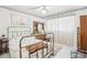 Bright bedroom with a metal frame bed, dresser, and decorative accents at 6544 S West Shore Cir, Tampa, FL 33616