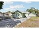 Charming exterior featuring a green house with a carport and a driveway at 6544 S West Shore Cir, Tampa, FL 33616