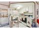 Functional kitchen with white cabinets, tile backsplash, and breakfast bar seating at 6544 S West Shore Cir, Tampa, FL 33616