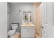 This is a bathroom with a white vanity and shower with neutral beige tiles at 7110 N Rome Ave, Tampa, FL 33604
