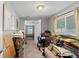 Cluttered bedroom with gray walls, two windows, and doorway to adjacent space at 7110 N Rome Ave, Tampa, FL 33604