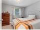 Cozy bedroom featuring a bed, dresser, and window with natural light at 7110 N Rome Ave, Tampa, FL 33604