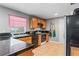 This kitchen features oak cabinets, black countertops, and tile flooring at 7110 N Rome Ave, Tampa, FL 33604