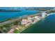 Stunning aerial view of waterfront condos with beach access, a bridge, and beautiful blue waters at 7430 Sunshine Skyway S Ln # 402, St Petersburg, FL 33711