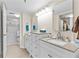 Bathroom featuring double sinks, vanities, and a glass-enclosed shower for a spa-like experience at 7430 Sunshine Skyway S Ln # 402, St Petersburg, FL 33711