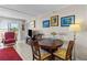The dining area features a wood table with chairs and art on the wall at 7430 Sunshine Skyway S Ln # 402, St Petersburg, FL 33711