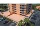Condo complex featuring a large outdoor patio area with seating and palm trees at 7430 Sunshine Skyway S Ln # 402, St Petersburg, FL 33711