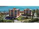 Waterfront condo complex with lush landscaping, outdoor seating, and stunning bay views at 7430 Sunshine Skyway S Ln # 402, St Petersburg, FL 33711