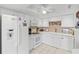 Bright kitchen featuring white cabinets, modern appliances, and a stylish backsplash at 7430 Sunshine Skyway S Ln # 402, St Petersburg, FL 33711