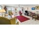 The living room has tile floors, furnishings, and sliding glass doors that bring in light at 7430 Sunshine Skyway S Ln # 402, St Petersburg, FL 33711
