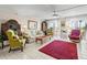 Living room with tile flooring, furniture, ceiling fan, and sliding glass doors to the outside at 7430 Sunshine Skyway S Ln # 402, St Petersburg, FL 33711