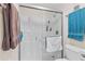 Shower with glass doors, shelving, and modern fixtures, providing a clean and functional space at 7430 Sunshine Skyway S Ln # 402, St Petersburg, FL 33711