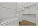 Bright walk-in closet includes a stacked washer and dryer and well-organized shelving and drawers at 777 N Ashley Dr # 2807, Tampa, FL 33602