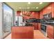 Modern kitchen features stainless steel appliances, black backsplash, dark countertops, and an island with balcony access at 777 N Ashley Dr # 2807, Tampa, FL 33602