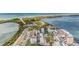 High angle aerial view of condos with a swimming pool and surrounding coastal scenery at 9 Forbes Pl # 504, Dunedin, FL 34698
