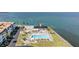 Overhead view of a pristine outdoor swimming pool, solar panels, and lounge chairs at 9 Forbes Pl # 504, Dunedin, FL 34698