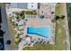Aerial view of community pool with ample lounge seating and manicured landscaping at 9 Forbes Pl # 504, Dunedin, FL 34698