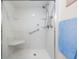 Modern bathroom shower with glass door, bench seat, safety bars and handheld shower head at 9 Forbes Pl # 504, Dunedin, FL 34698