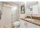 Full bathroom featuring a shower stall, granite vanity and decorative framed artwork at 9 Forbes Pl # 504, Dunedin, FL 34698
