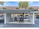 View of covered parking area with spaces for multiple cars and bicycles with security gating at 9 Forbes Pl # 504, Dunedin, FL 34698