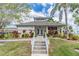 Beautiful clubhouse featuring manicured landscaping, concrete stairs, and a welcoming entrance at 9 Forbes Pl # 504, Dunedin, FL 34698