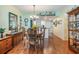 Dining room adjacent to the kitchen featuring wooden furniture and laminate floors at 9 Forbes Pl # 504, Dunedin, FL 34698