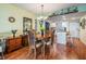 Cozy dining room area adjacent to the kitchen featuring hardwood floors and a chandelier at 9 Forbes Pl # 504, Dunedin, FL 34698