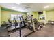 Well-equipped gym featuring treadmills, bikes, weight machines, and bright, colorful walls at 9 Forbes Pl # 504, Dunedin, FL 34698