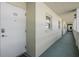 Exterior hallway of the building showing unit entrances and multiple windows at 9 Forbes Pl # 504, Dunedin, FL 34698