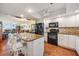 Renovated kitchen featuring granite countertops, stainless appliances, and an open view to the living area at 9 Forbes Pl # 504, Dunedin, FL 34698