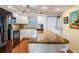 Well-lit kitchen with granite countertops, white cabinetry, and modern appliances at 9 Forbes Pl # 504, Dunedin, FL 34698
