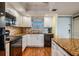 Bright kitchen featuring granite countertops, modern appliances, and ample cabinet space at 9 Forbes Pl # 504, Dunedin, FL 34698