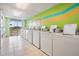 Bright laundry room with multiple washing machines and ample lighting at 9 Forbes Pl # 504, Dunedin, FL 34698