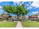 Exterior community park with lush greenery, seating areas, and mature trees at 9 Forbes Pl # 504, Dunedin, FL 34698