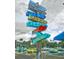 Collection of directional signs pointing to various restaurants, bars, and tourist attractions at 9 Forbes Pl # 504, Dunedin, FL 34698