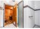 Sauna and bathroom, featuring tile floors, wooden walls, and a frosted glass door at 9 Forbes Pl # 504, Dunedin, FL 34698