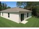 Picture of backyard, landscaping, a sliding glass door, and newly installed sod at 9002 Glenarm Way, Weeki Wachee, FL 34613